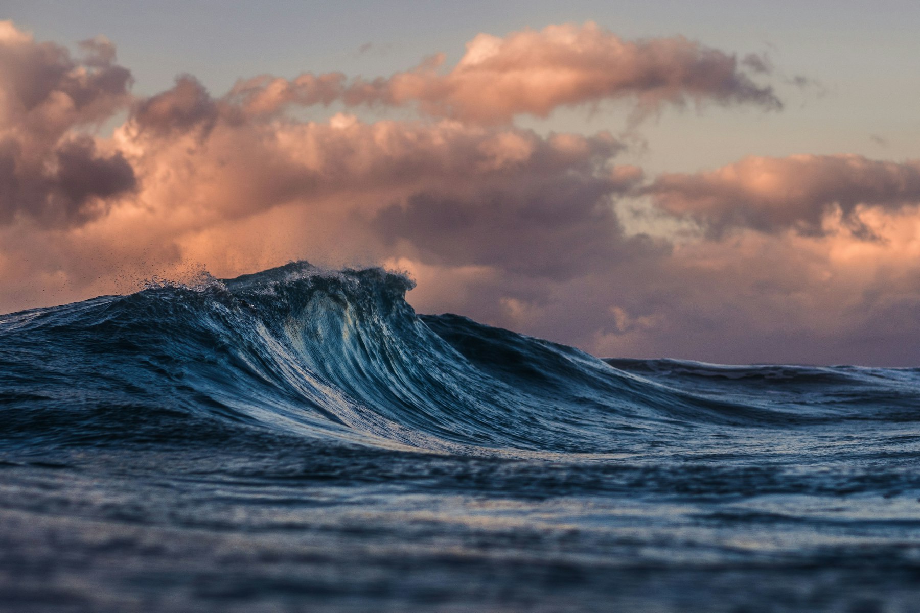 Wave breaking at sunset